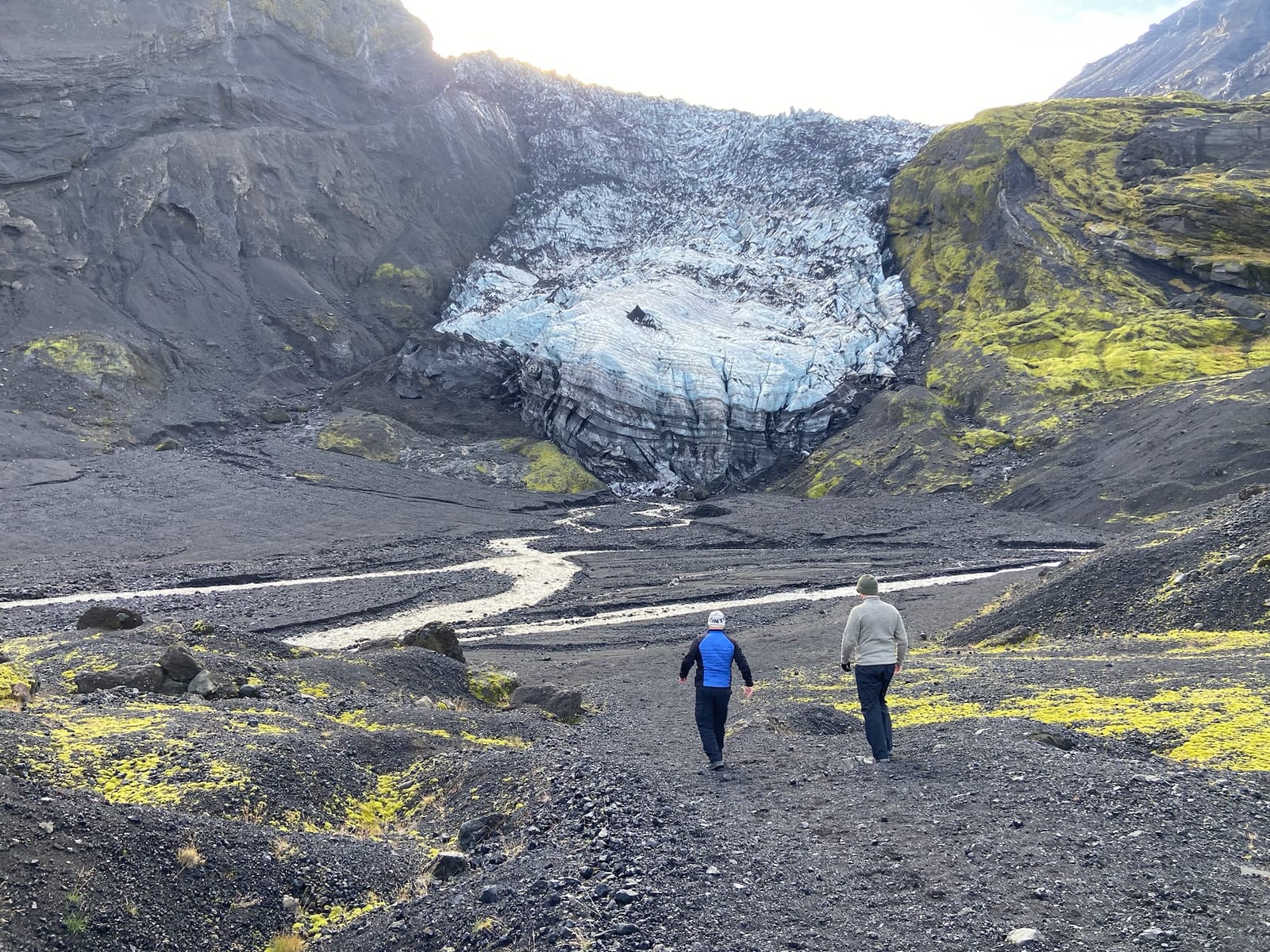 The glacier tongue of Eyjafjallajokull spilling between dark ridges