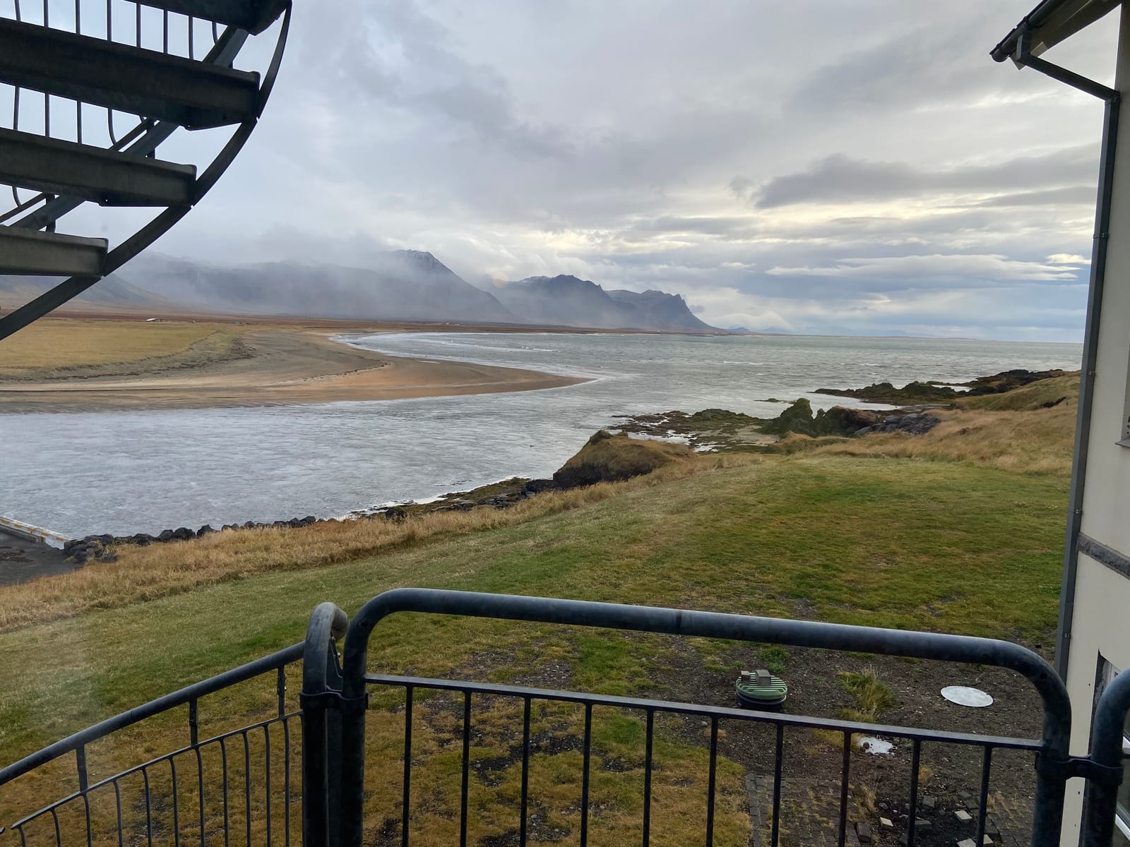 The view from a Hotel Budir balcony over the black-sand spit and mountains