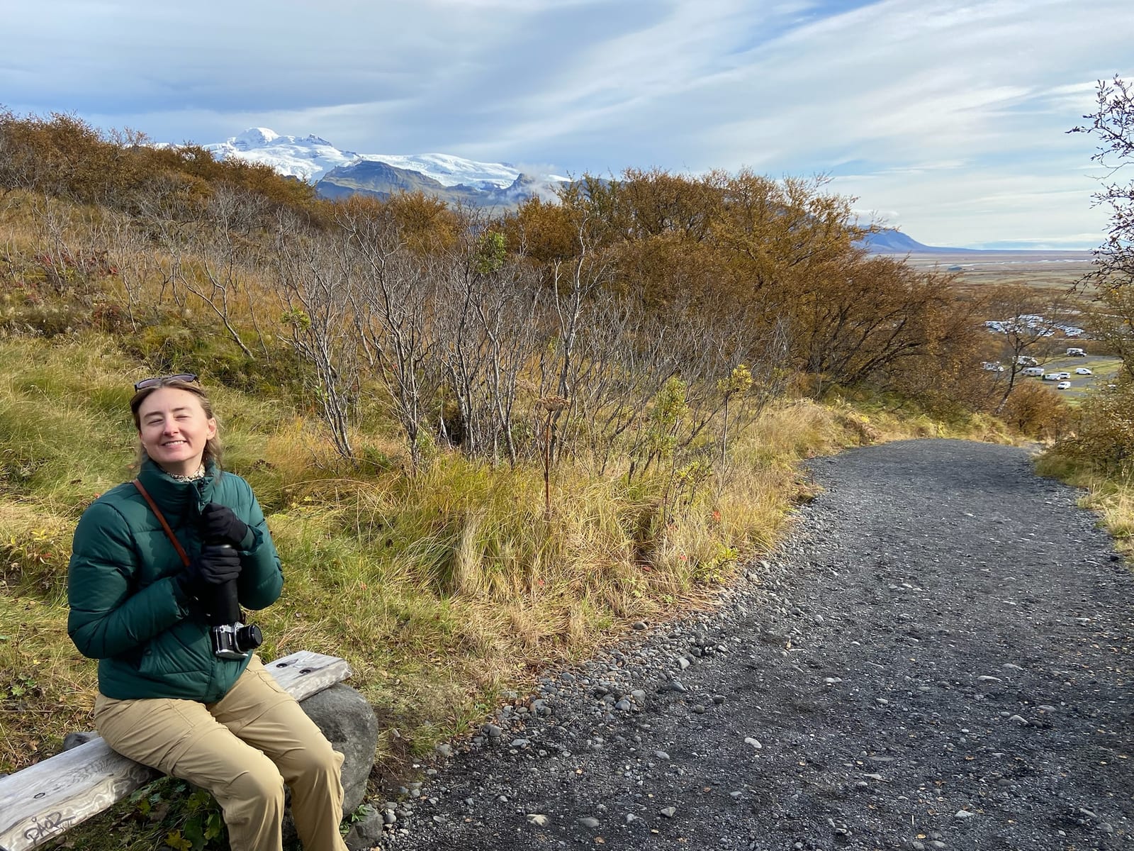 A hiker resting on the gravel Skaftafell trail in autumn