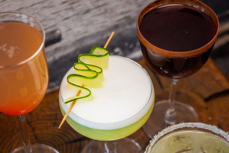 A row of garnished cocktails on the bar at Slippbarinn