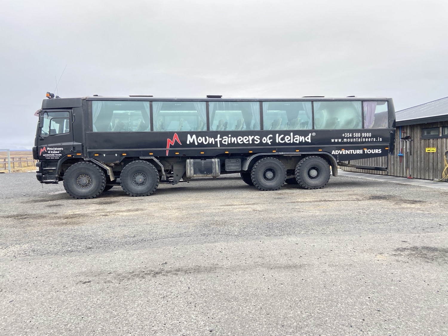 A black Mountaineers of Iceland super bus on huge tires