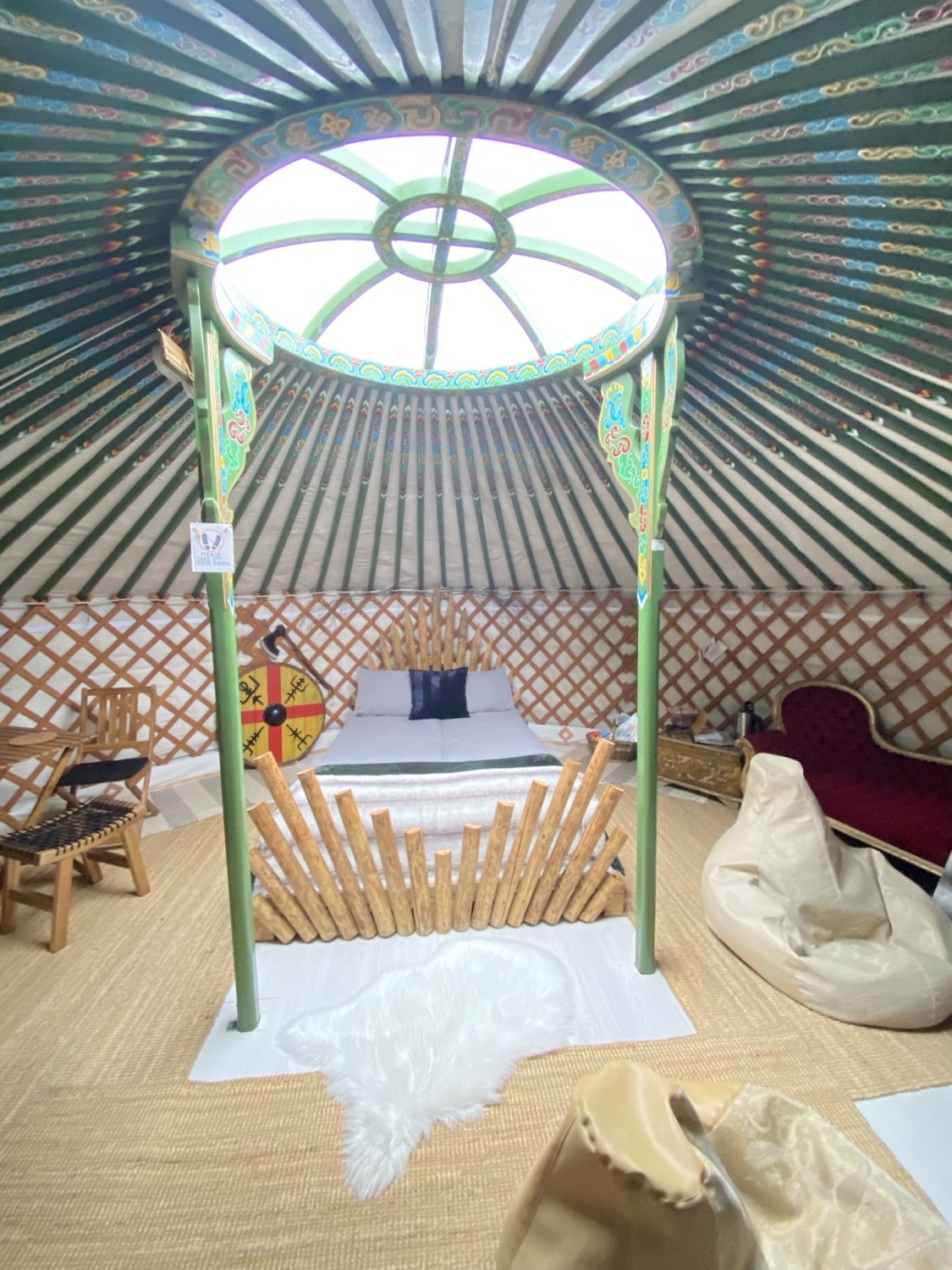 Inside the yurt, looking up at the painted wooden dome