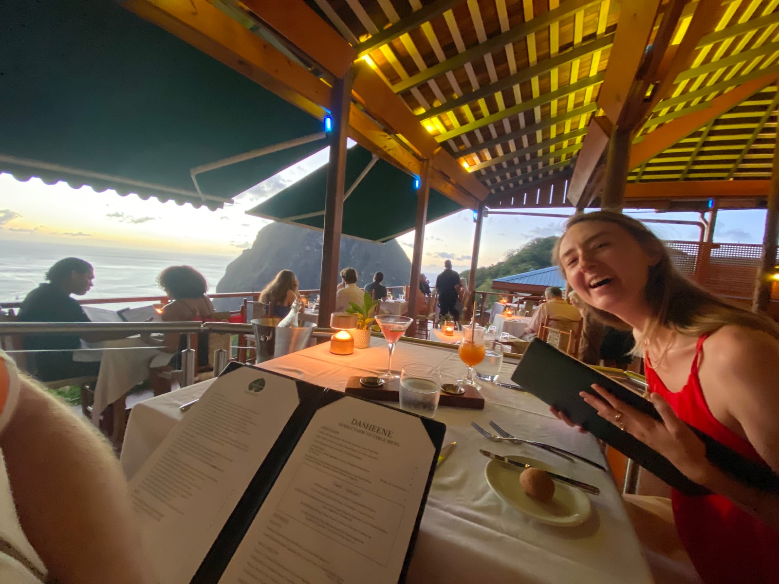 A candlelit table at Dasheene with the Piton coast beyond