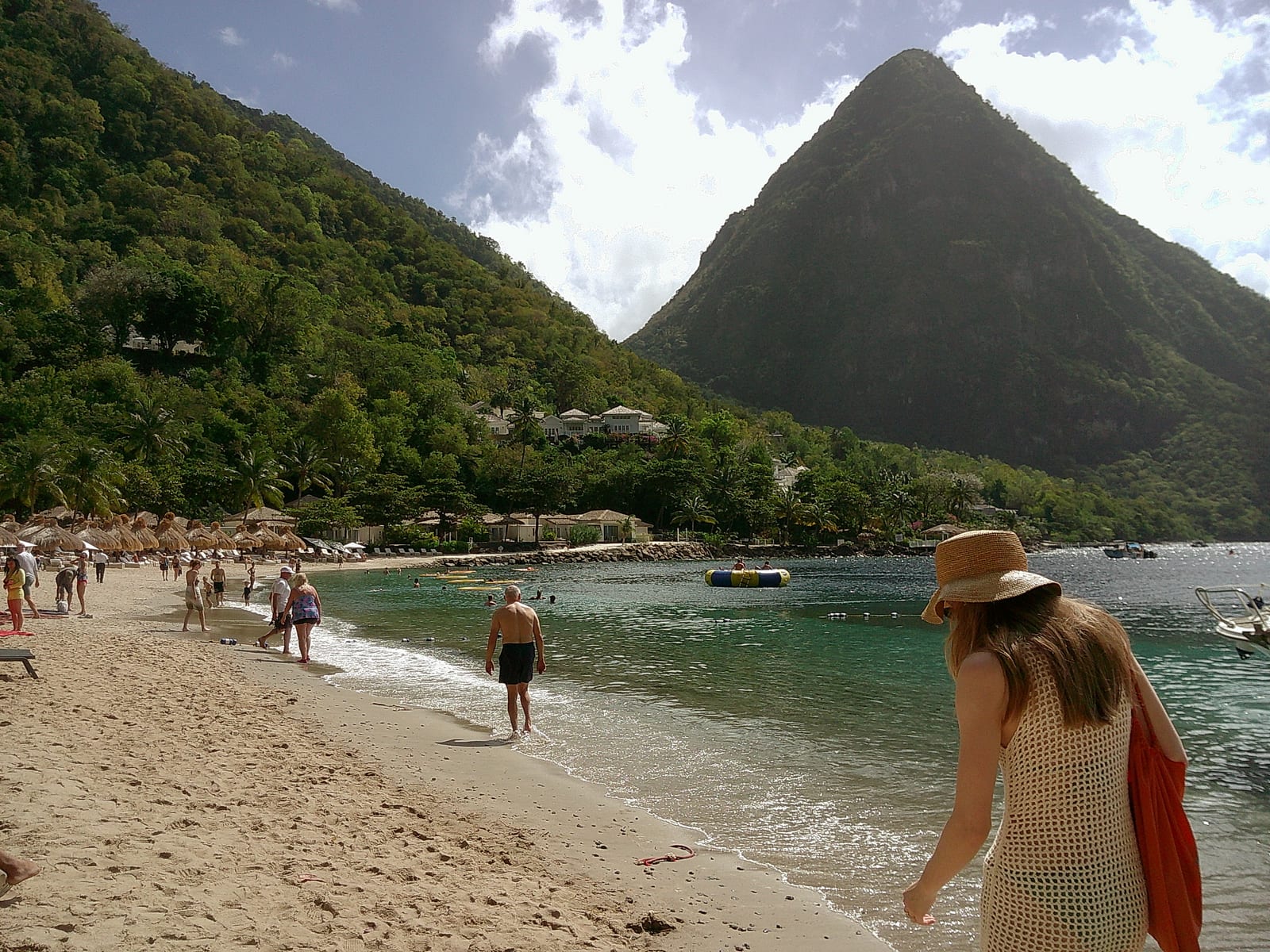 People on Sugar Beach below a Piton