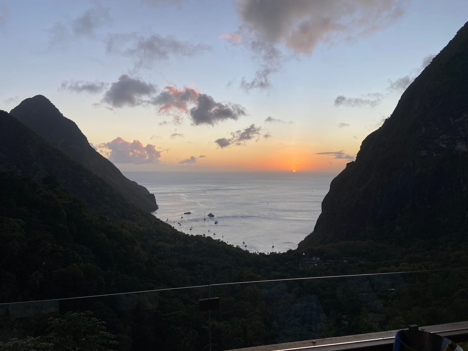 The sun setting on the sea between the two Pitons